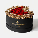 Black heart-shaped box with 28-30 red and gold roses inside