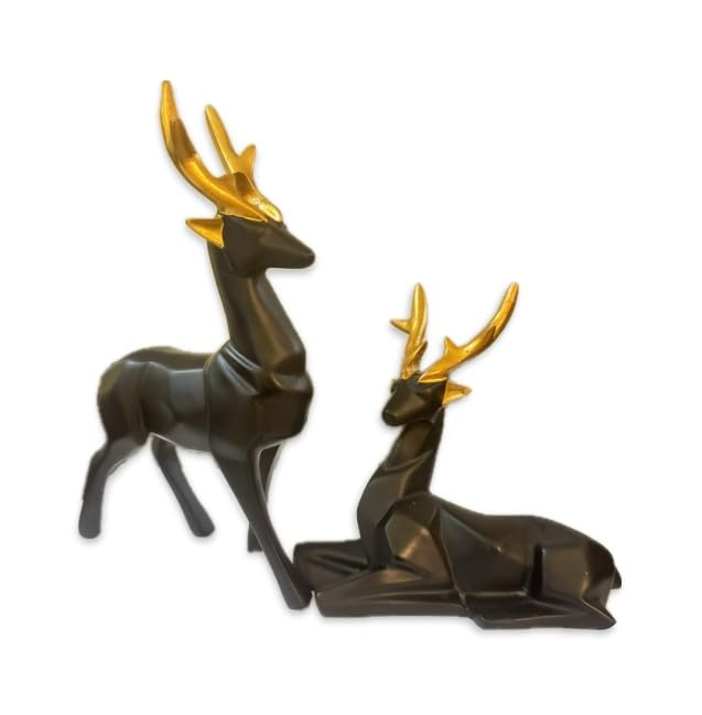 Two sleek black and gold resin deer figurines displayed on a wooden surface