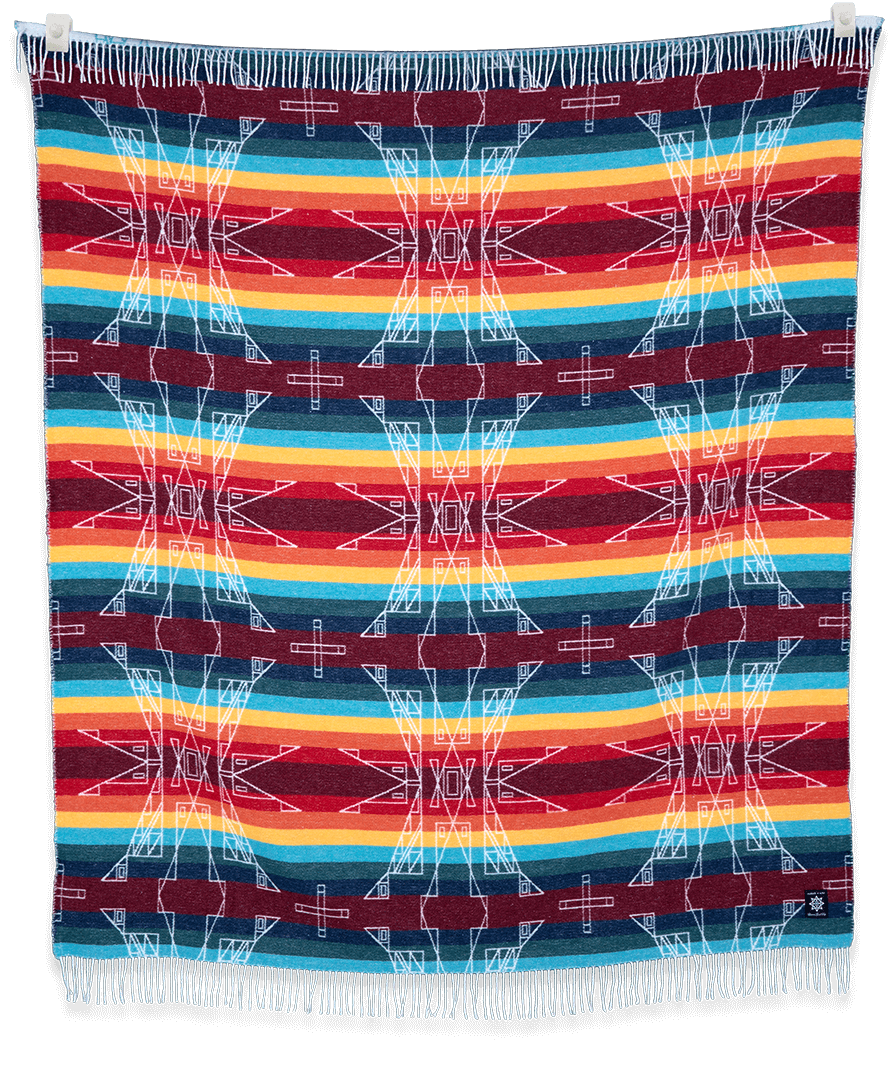 AwirítkAt (Summer) blanket displayed folded and hanging, showing its warm neutral colors and texture.