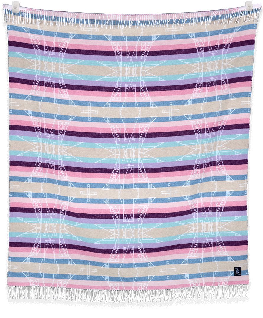 Hunaaneeká (Spring) blanket showing a blend of warm and muted tones draped indoors