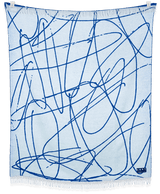 LANY blanket showing hand-drawn design and neutral colors, displayed draped on furniture and hanging