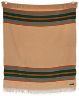 Camp Blaze blanket draped over a white sofa in a living room setting