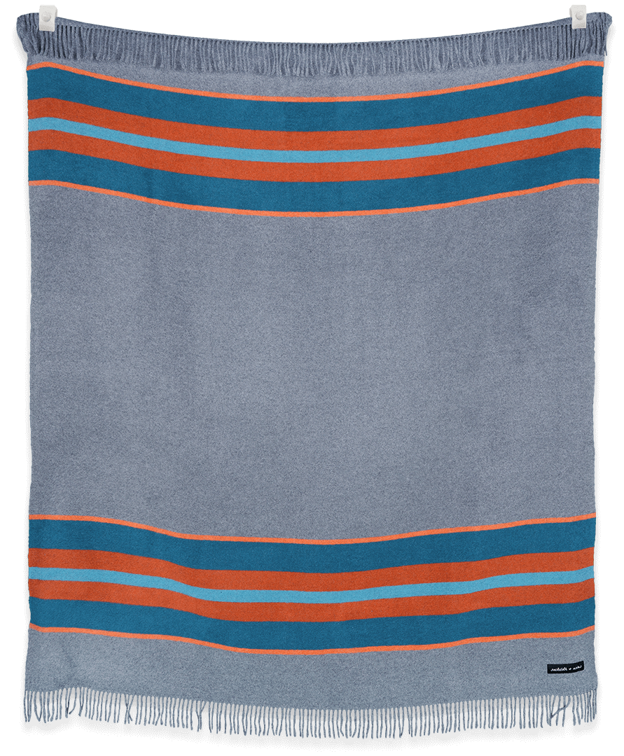 Camp Rapids blanket by Sackcloth & Ashes displayed folded and hanging, showing neutral tones and soft texture