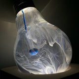 EP Light Blue-Drop Resin LED Bulb handcrafted with eco-friendly resin, shown with wooden base options