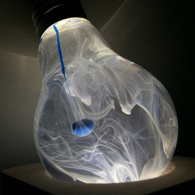 EP Light Blue-Drop Resin LED Bulb handcrafted with eco-friendly resin, shown with wooden base options