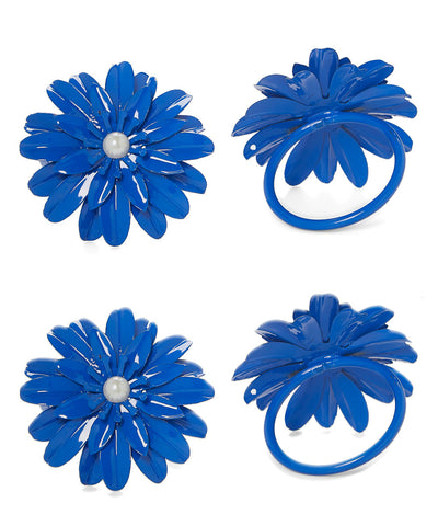 Set of 4 blue floral pearl napkin rings arranged on a table