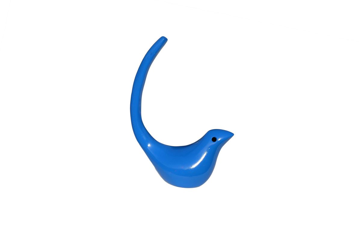 Smooth blue bird-shaped jewelry holder with an elongated tail curved upward and a small black eye detail on the head.