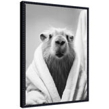 Black and white framed canvas art featuring a capybara wearing a towel robe by The Creative Bunch Studio