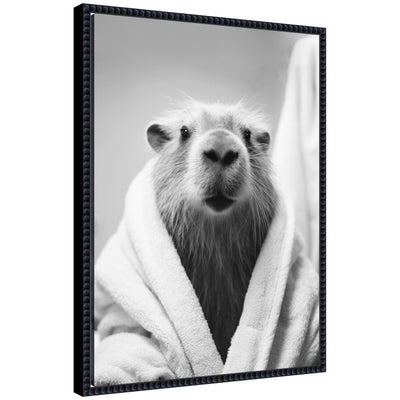 Black and white framed canvas art featuring a capybara wearing a towel robe by The Creative Bunch Studio