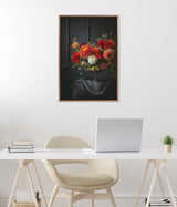 Framed canvas print of a dark floral still life with red, orange, and white flowers in a vase on a black draped surface against a deep gray background.