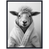 Black and white portrait of a sheep with fluffy wool wearing a soft, white bathrobe, framed with a dark textured border.