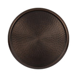 Round hammered metal tray with a dark bronze finish and raised edge, showing textured concentric patterns radiating from the center to the rim.