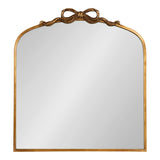 Arched mirror with a gold frame featuring a sculpted ribbon bow centered at the top, blending simple rectangular base with a graceful curved upper edge.