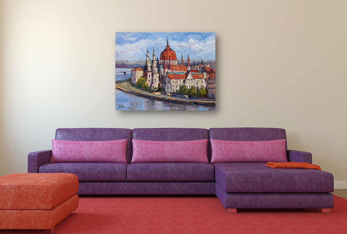 Colorful canvas painting of Budapest's Parliament along the river, hung above a purple sectional sofa with pink cushions in a modern living room.