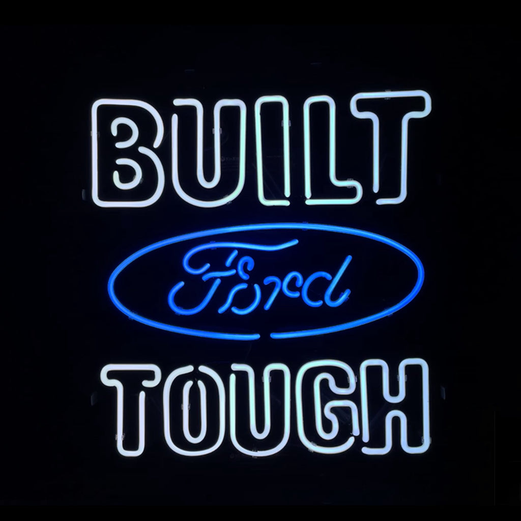 Built Ford Tough Neon Sign glowing in warm red neon on metal grid backing