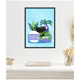 Framed canvas wall art showing a black cat peeking among three blue and white patterned plant pots with green leaves against a light blue background.