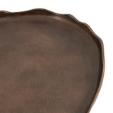 Close-up of an oval table surface with a wavy, irregular edge in textured dark brown wood finish