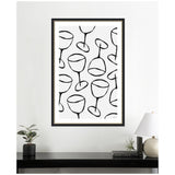 Framed print featuring a repeated minimalist black line drawing of wine glasses on a white background, hanging centered above a black console with a lamp and plants.