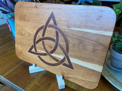 Cherry wood charcuterie board with Celtic Knot triquetra inlay made of Peruvian walnut