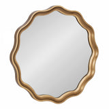 Round mirror with a wavy scalloped frame in brushed gold finish against white background.