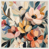 Abstract bouquet of large, soft-petaled flowers in cream, peach, orange, yellow, with dark centers and blue-green leaves on a light background.