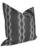 Charcoal-colored pillow cover with vertical wavy white lines in a textured woven fabric, shown with a pointed, full shape against a white background.