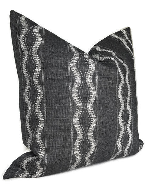 Charcoal-colored pillow cover with vertical wavy white lines in a textured woven fabric, shown with a pointed, full shape against a white background.