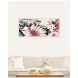 Framed rectangular canvas featuring a close-up of pink and white flowers with green leaves, hanging above a beige sofa with a white cushion and wooden coffee table.