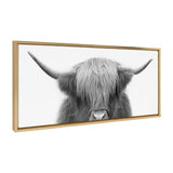 Framed canvas wall art showing a close-up black and white photograph of a Highland cow with long hair covering its eyes and wide curved horns extending outward.
