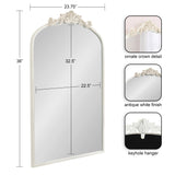 Tall white arched mirror with ornate crown detail at top, measuring 36 by 23.75 inches, featuring an antique white finish and a keyhole hanger on the back.