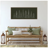 Minimalist dark green canvas with white sketch of evergreen trees, framed and hanging above a wooden bench with green and white pillows and small potted tree.