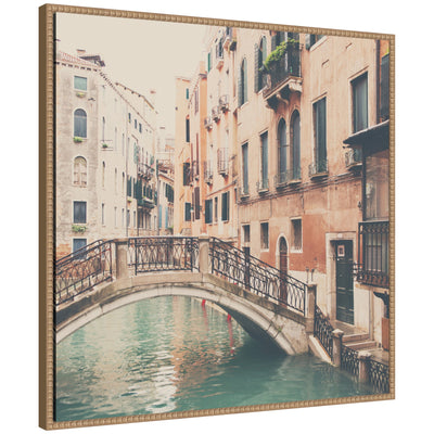 Framed canvas art showing a street scene in Venice with architecture, in a gray polystyrene frame
