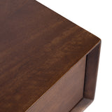 Close-up of a brown wooden surface corner with a smooth finish and subtle grain visible on the McCutcheon Floating Console Table.