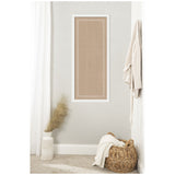 Rectangular beige pinboard with white scalloped edge frame mounted on a light gray wall, accompanied by a textured white vase with pampas grass and a woven basket with a white blanket.