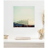 Framed wall art print featuring a close-up of a green and white striped beach umbrella against a pale sky with soft focus background, displayed above a minimalist white desk.