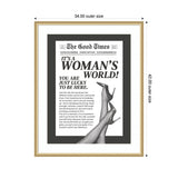 Black and white framed print styled as a vintage newspaper front page titled 'The Good Times' with headline 'It's a Woman's World!' and a photo of crossed legs in high-heeled shoes.