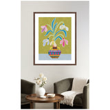 Framed colorful stylized snowdrops illustration by Rachel Lee with pink, white, and blue petals and striped multicolor vase on olive green background, hanging above a small round table and chairs.