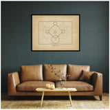 Framed vintage-style baseball diamond diagram with labeled bases on beige paper, hanging on a dark teal wall above a tan leather sofa with a small wooden coffee table.