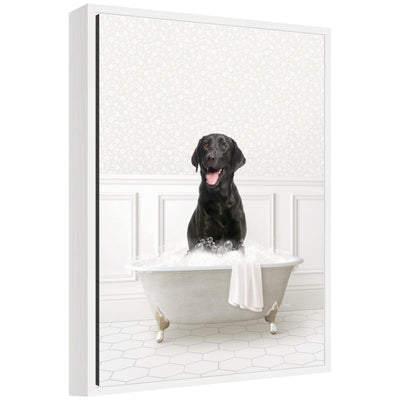 Framed canvas art of a black Labrador puppy sitting in a white bathtub