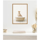 Framed canvas of a cheetah sitting inside a vintage terrazzo bathtub with a pale textured wall background, displayed above a minimalist desk with dried floral decor.