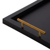Close-up of a black rectangular decorative tray corner with a sleek gold cylindrical handle mounted horizontally.