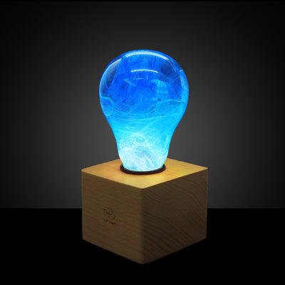 EP Light Memory Resin LED Bulb handcrafted with eco-friendly resin, shown with wooden base options