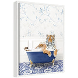 Framed canvas art depicting a tiger resting in a blue bathtub surrounded by eclectic, colorful decor accents.