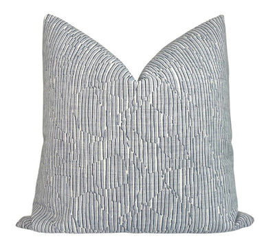 Cadence Striped Pillow Cover in Denim Blue displaying blue striped woven fabric on the front and ivory outdoor fabric backing
