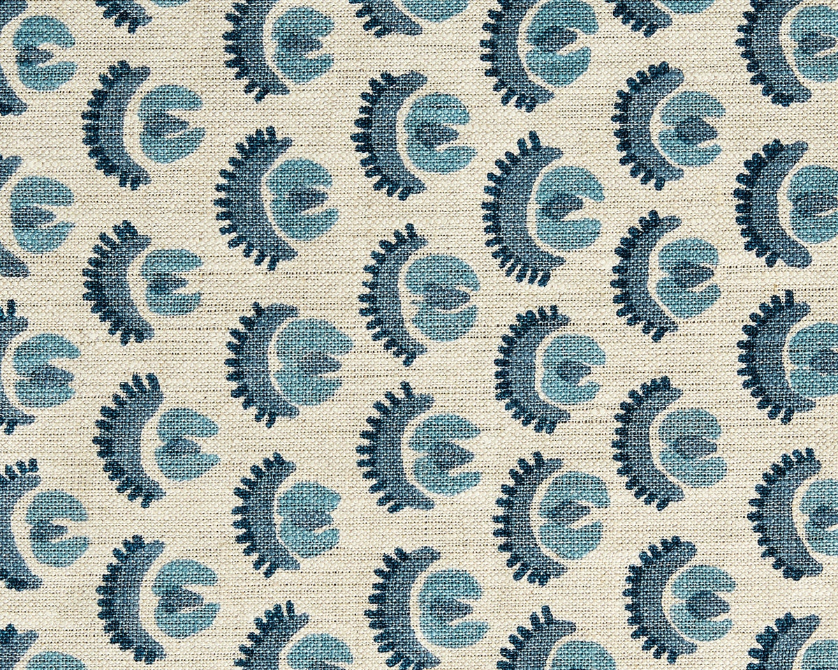 Repeating pattern of stylized blue and dark blue floral shapes on a textured beige fabric background with diagonal woven texture.