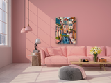 Brightly colored painting of a narrow canal with a small arched bridge and surrounding buildings, hanging on a pink wall above a pink sofa in a sunlit room.