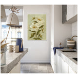 Framed canvas wall art of large white flowers with green leaves on a muted olive background, hanging on a white wall in a modern kitchen.