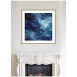 Abstract framed artwork above a carved white fireplace, featuring deep blue and white watery textures creating a rich, fluid pattern.