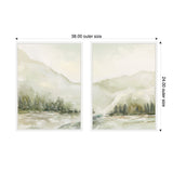 Two framed canvas prints each depicting a soft, muted winter landscape with misty hills, evergreen trees, and pale gray and green tones in a diptych arrangement.