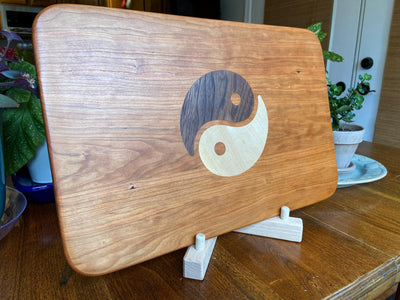Cherry wood charcuterie board with Yin Yang inlay made from Peruvian walnut and maple